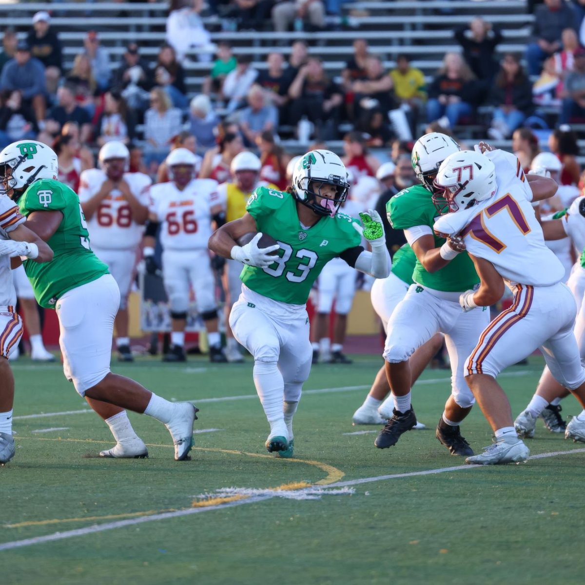 The Thousand Oaks offensive line blocks for junior running back Justin Lewis as he finds a gap on his opening rush against the El Modena Vanguards on Friday, Aug. 23, 2024, in Thousand Oaks Calif. The Lancers were defeated at home 41-34 in overtime by the Vanguards. (The Lancer/Alan Ko)