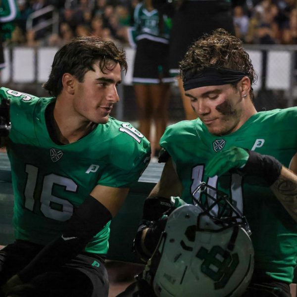 Captain safety Jack Steinberg and linebacker Jameson Born talk on the bench after a solid defensive drive at the Lancer's homecoming game on September 20th, 2024.