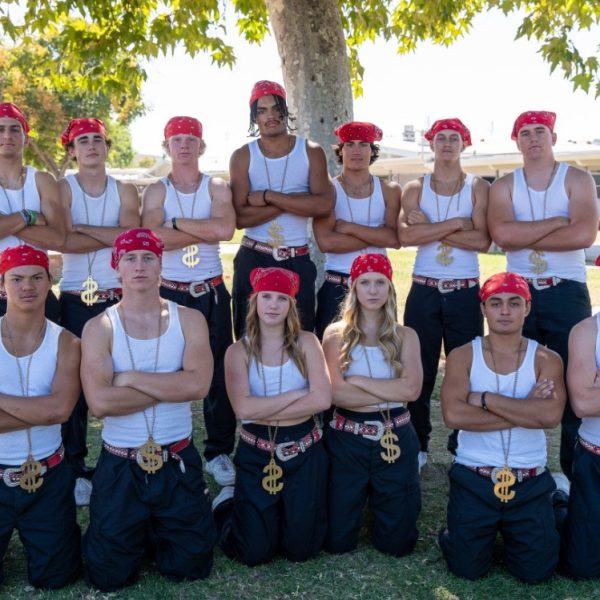 BRINGING HOME THE WIN - Varsity group leader Riley Speed takes a photo with her football dance crew before taking home a win at the night show.