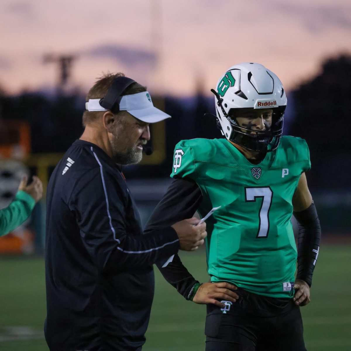 QUICK CHAT - Former coach Ben McEnroe chats with Jackson Taylor during a game.